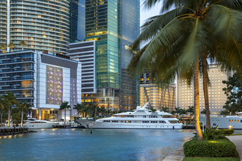EB-5 Regional Center in Florida. Photo of a boat pulled up right along skyscrapers in Miami, Florida.