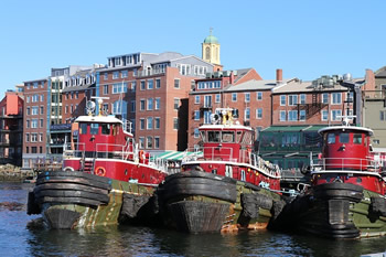 EB-5 Regional Center in New Hampshire. Photo of tug boats docked at shore of Portsmouth, New Hampshire.